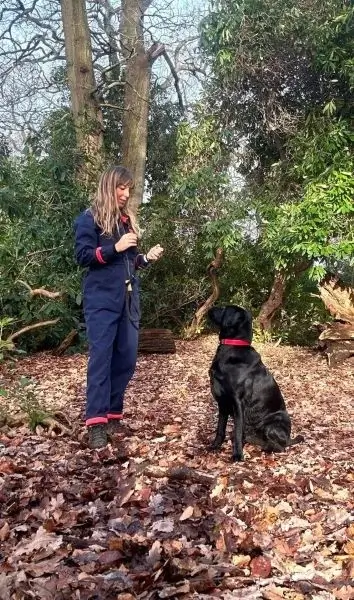 Hannah with large sitting dog in Autumn